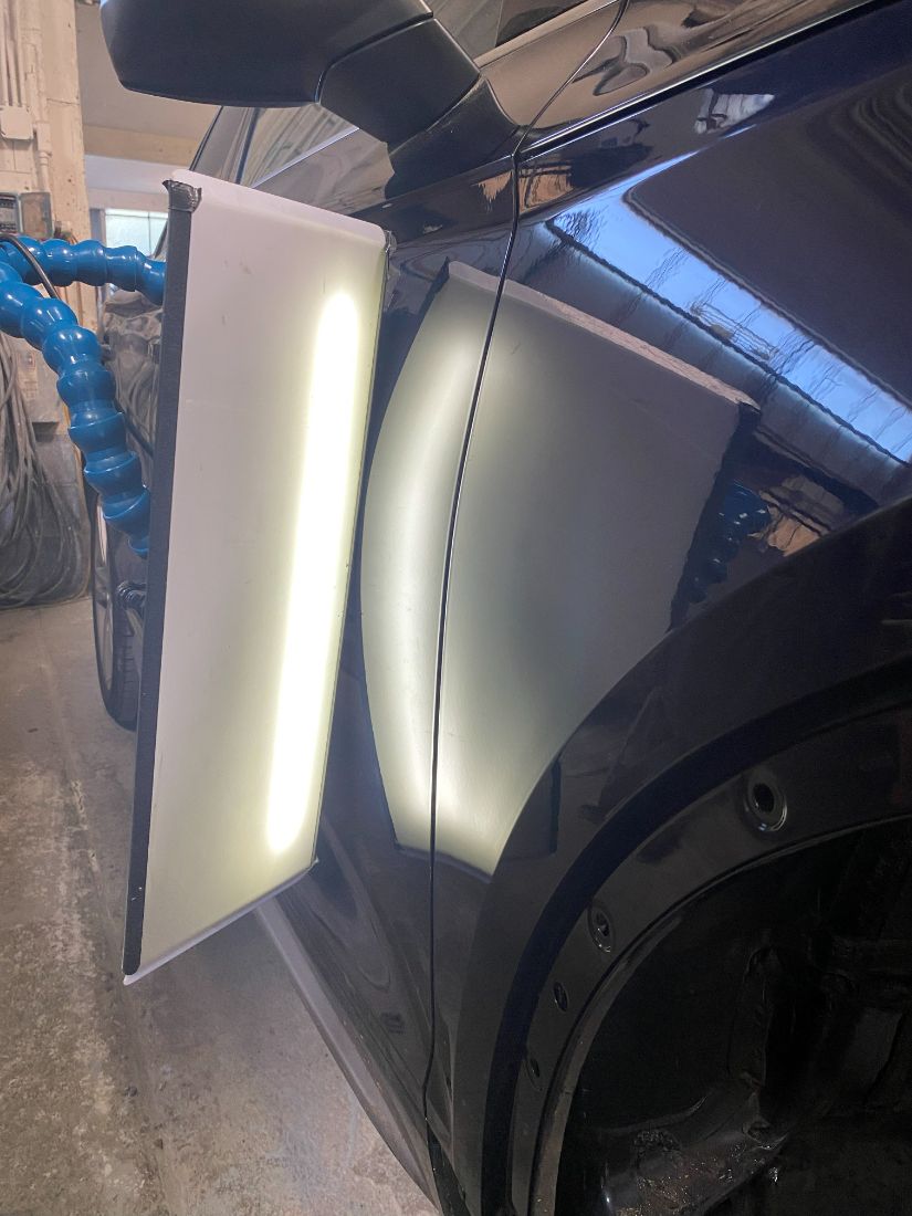 The same silver fender after paintless dent repair